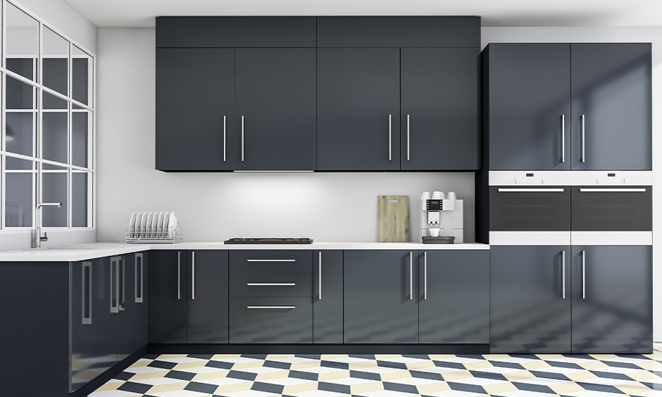 White l-shaped Indian kitchen cupboard design in black matt finish laminate look aesthetic.