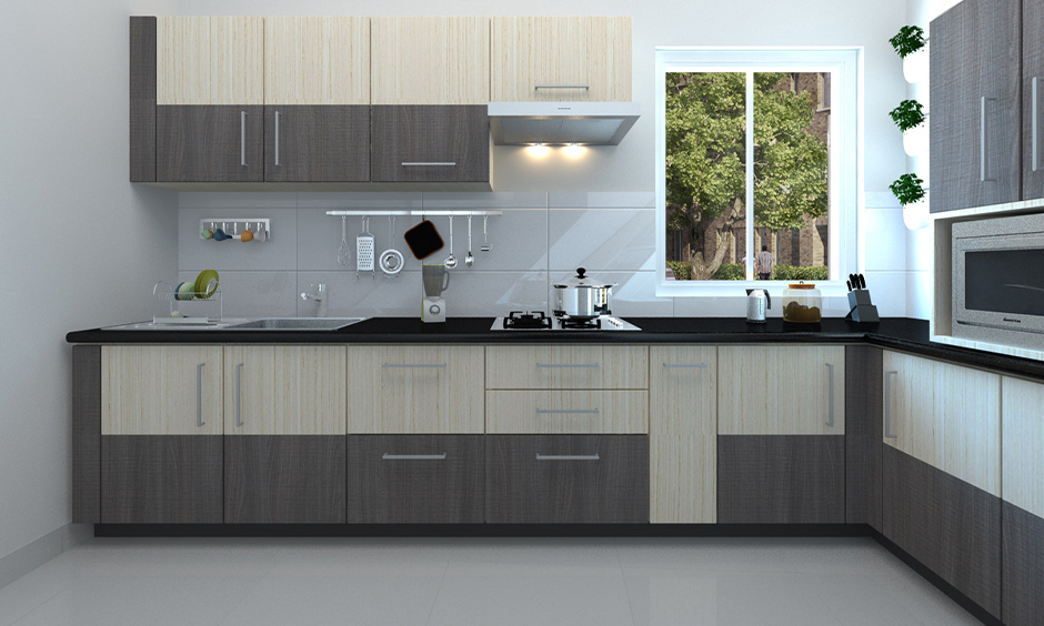 L-shaped grey Indian kitchen furniture design in brown and beige shiny laminate looks sleek.