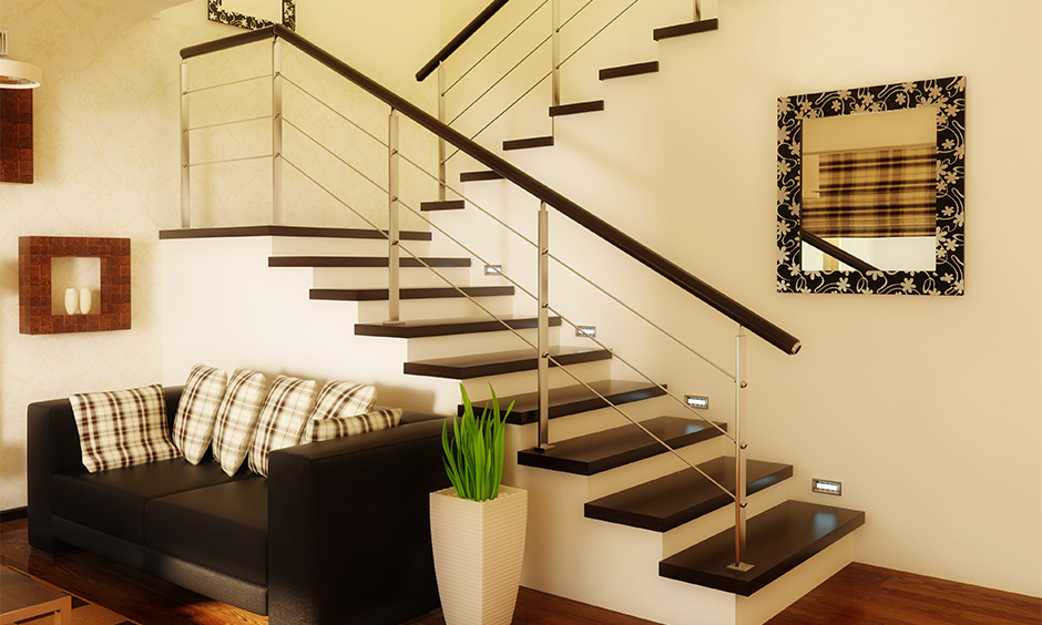 The black marble design on stairs in the living room looks bold and modern.