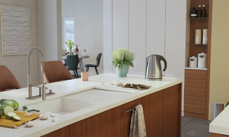 Integrated marble kitchen sink with drainboard and cabinets below in wooden finish in the island kitchen look chic.