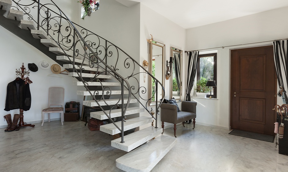 Italian marble stairs design with metal railing in the luxury duplex house looks aesthetic.