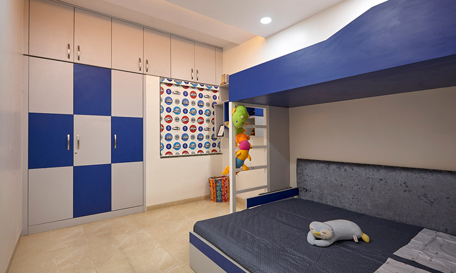 Kids bedroom designed by dc interior design company in Kalyan City Mumbai with bunk bed and wardrobe looks minimal.