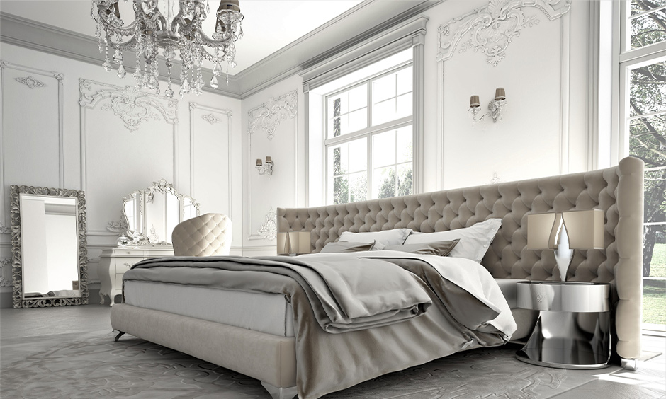 Off-white bedroom in modern french interior design with vintage dressing table and chandelier look sleek.