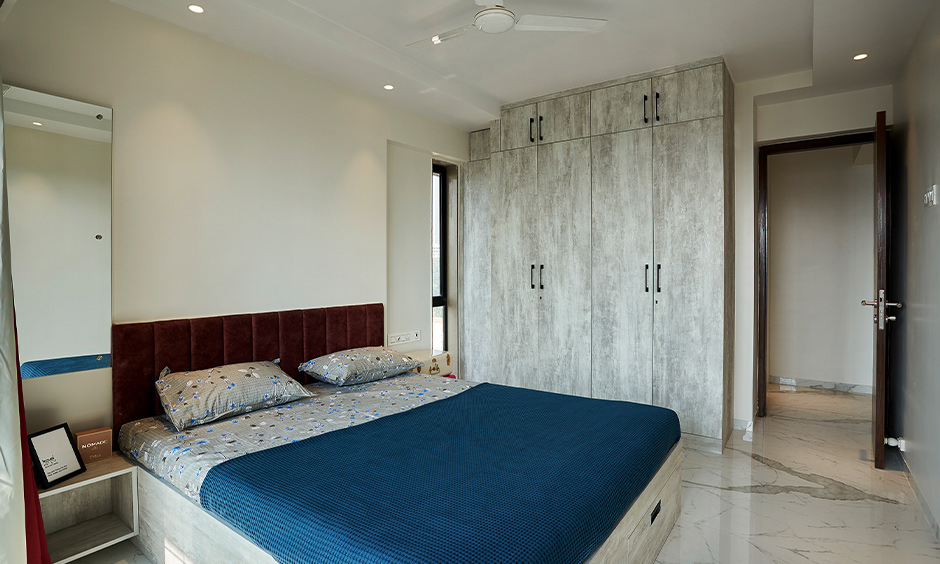 Mumbai flats interior design with rustic looking guest bedroom