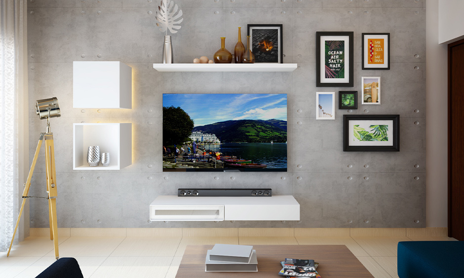 The photo gallery wall idea for the living room with arranged prints and photo frames around the tv unit looks minimal