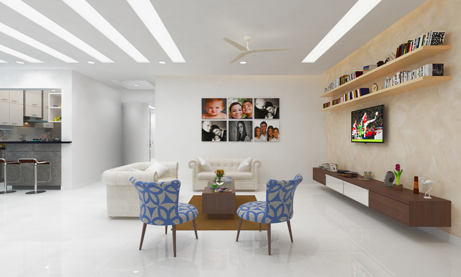 Porcelain modern white floor tiles in the living cum dining area look refreshing with two white sofas.