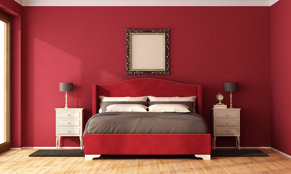 Romantic bedroom colors for couples with dark red wall and bedside tables in white