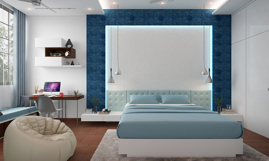 Blue and white bedroom cum study room designed with false ceiling and hanging lights stylish look.