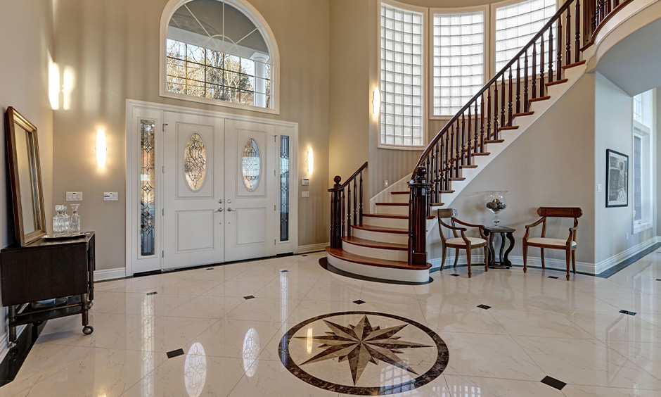 Elegant stair marble design with wooden railing in the hallway adds a vintage look to your modern home.