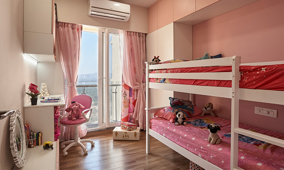 The pastel pink kids bedroom by interior design firms in navi mumbai