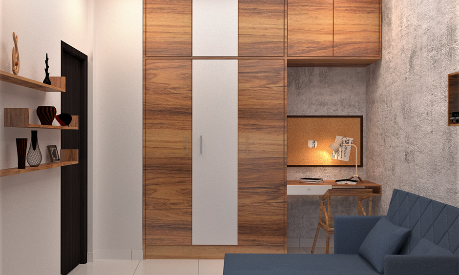 3 door wardrobe design with an attached study table in the wooden finish is a compact and space-saving design.