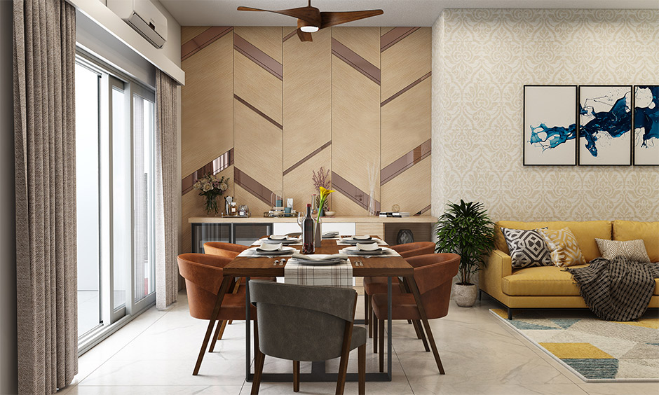 A combination of mirror and wooden wall design in living room cum dining area lends style and chic look.