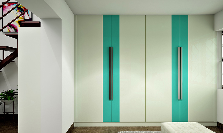 Bedroom wall wardrobe cabinet designed with pull-open doors in sea green and white linear pattern gives a contemporary vibe.