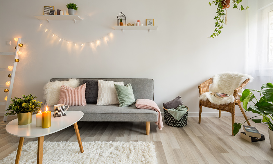 A white living room with grey laminate wood flooring brings a rustic vibe and creates a bold statement.