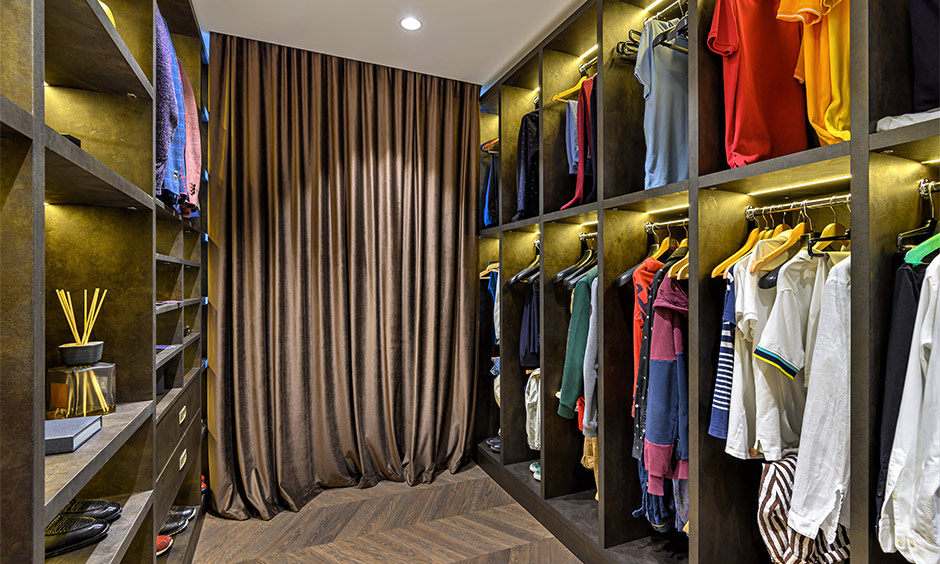 How to organise a man's wardrobe, Walk-in wardrobe with different open shelving with backlights is a space-saving design.