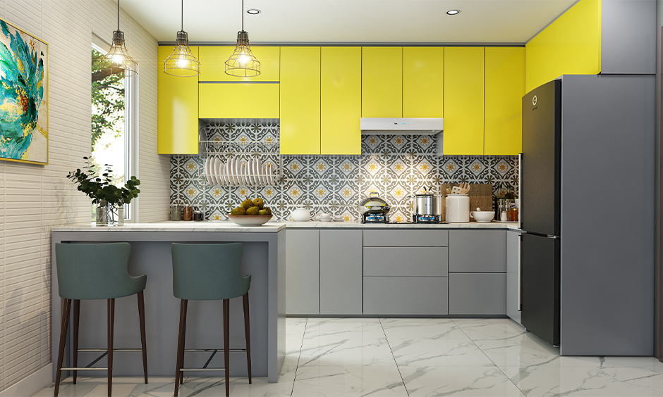 Indian small open kitchen design in yellow and grey colour combination adds vibrance to the area.