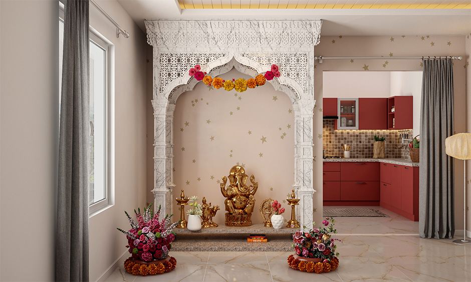 Jaali marble pooja room design from ceiling to floor with intricate carvings exudes a celestial vibe.