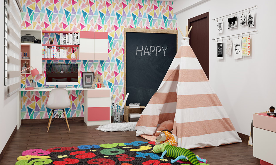 Kid's room wallpaper in geometric pattern design and study table with cabinets creates a mindful ambience.