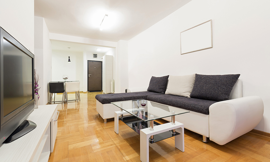 Natural laminate wood flooring design in the living room lends a classic touch to the area.