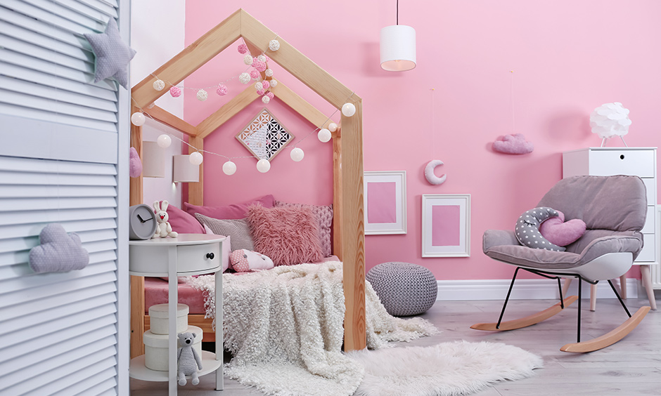 DIY girls room decorated with paper fairy lights hung around the bed creates warmth to the area.