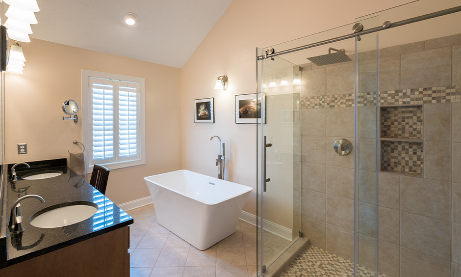 Shower area separated from rest of the bathroom with sliding glass door design for bathroom look spacious.