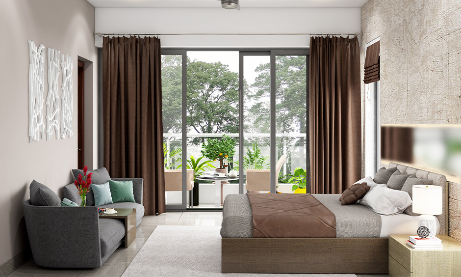 A huge sliding glass door design for the bedroom with a beautiful view of the balcony lends a sleek look.