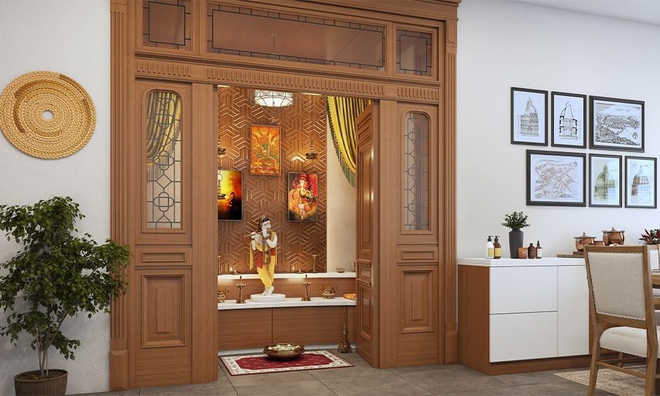 Traditional pooja room design with warm yellow lighting to diffuse a soft yellow glow over the intricate architecture