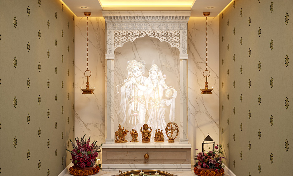 White Italian marble mandir design for home with a decorative lit wall panel adds a blissful charm to the area.