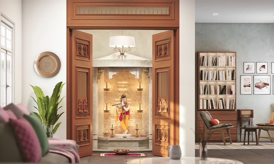 Wooden doors with modern motifs set a welcoming tone for the room for traditional pooja room designs with accent doors