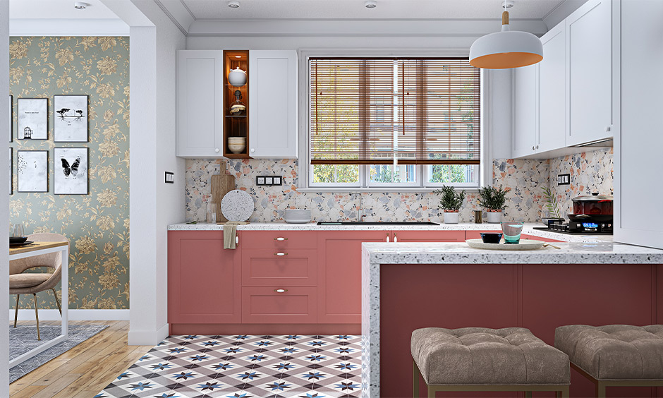 U-shaped Indian open kitchen design in pink and white colour adds soothing vibe with quartz countertop and backsplash.