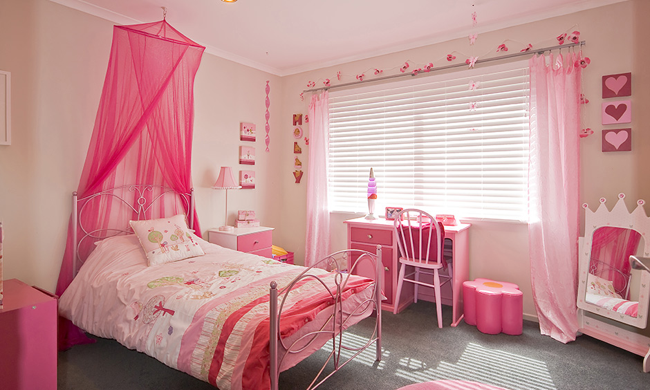 Pink girly DIY room decor with block signages hang around the window lends a beautiful look.