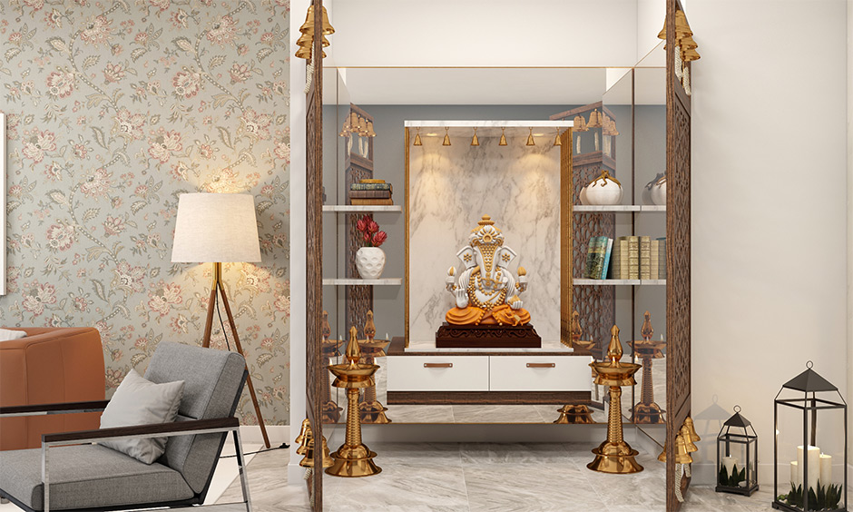 Wall-mounted marble pooja room design for home with mirrors behind the wall-mounted adds a classic look.