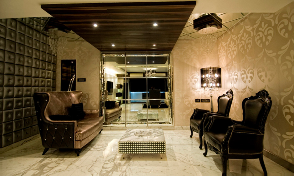 White marble tiles in the living room with rich texture and intricate patterns lend a grandeur look to the classic space.