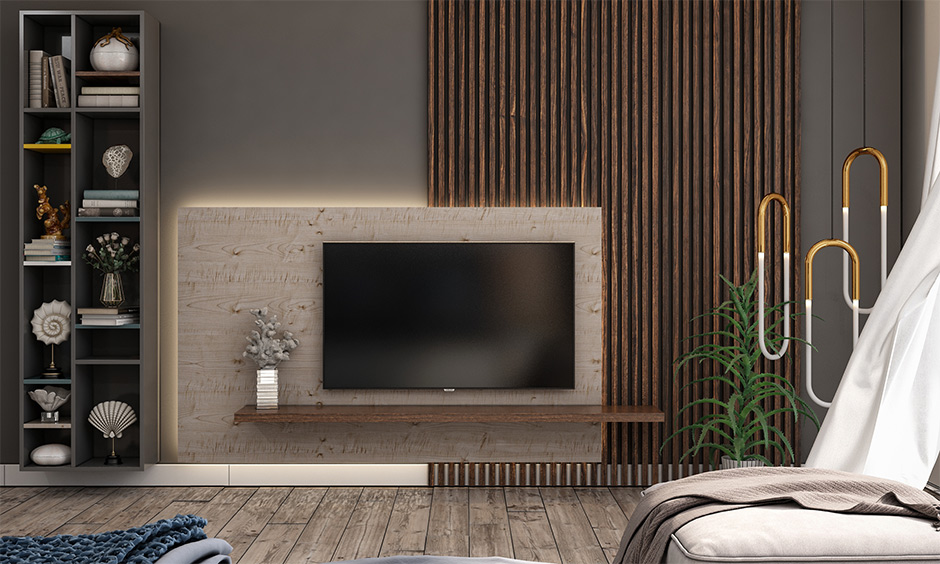 Wooden wall design in the living room with vertical slatted wall pattern gives a modern and sleek look.