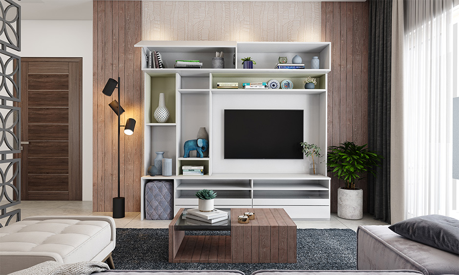 Wooden wall design in the living room with a dual-tone covering around the tv unit creates a unique look.