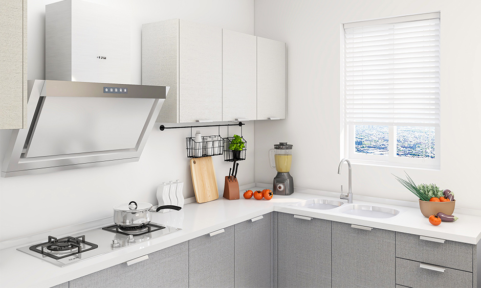 All-white Indian kitchen interior design has a window rolling shutter in minimalistic design.