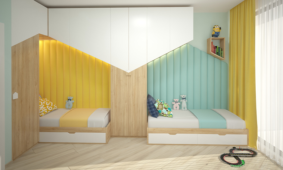 Back to back twin space saving kids beds made from light wood and side headboard in yellow and blue.