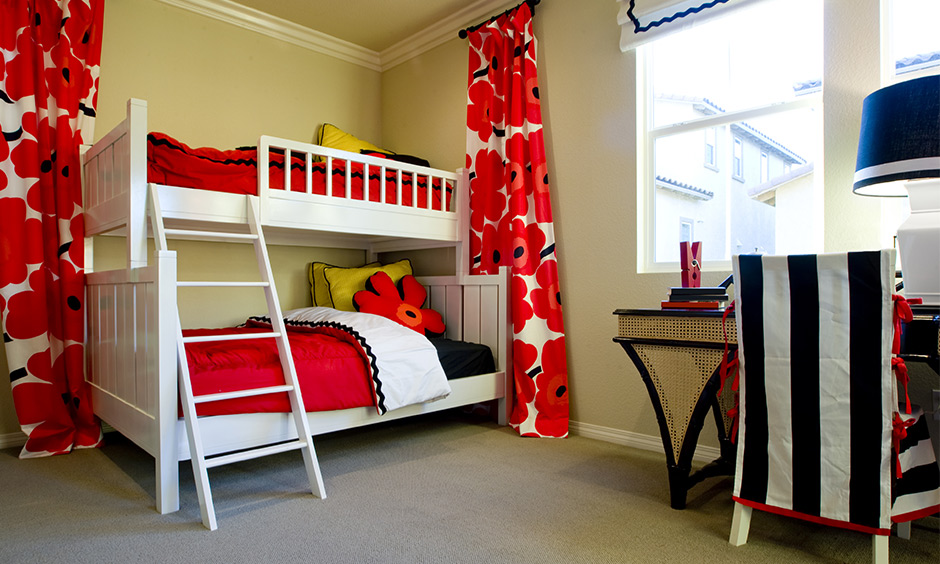 Bunk beds for kids girls with a playful vibe and with matching curtains and a chair cover