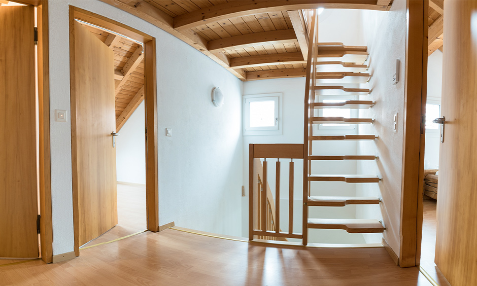 Contemporary oak staircase with wooden handrail creates a clean and minimal look to space