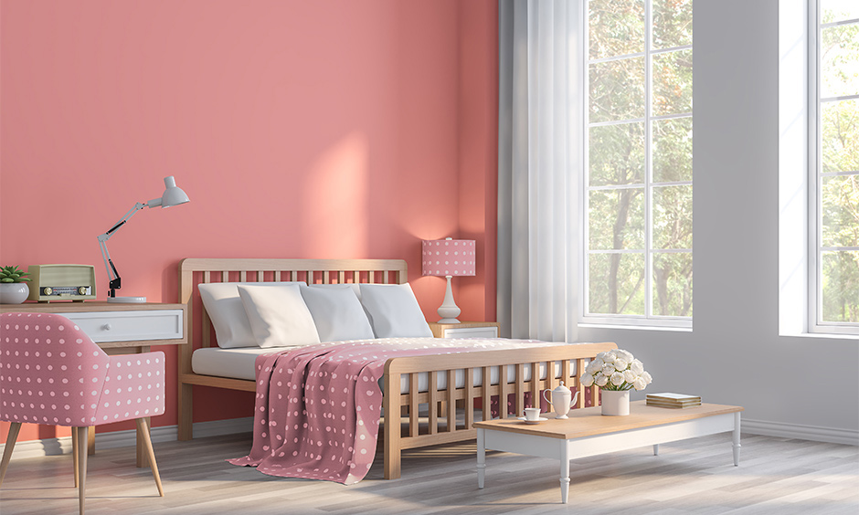 Guest room paint color in coral pink combined with the white wall colour and wooden flooring brings an earthiness.