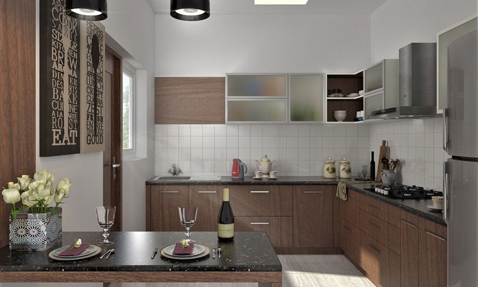 L-shaped kitchen has frosted modern style glass kitchen cabinets, and black pendant light gives a sleek look.