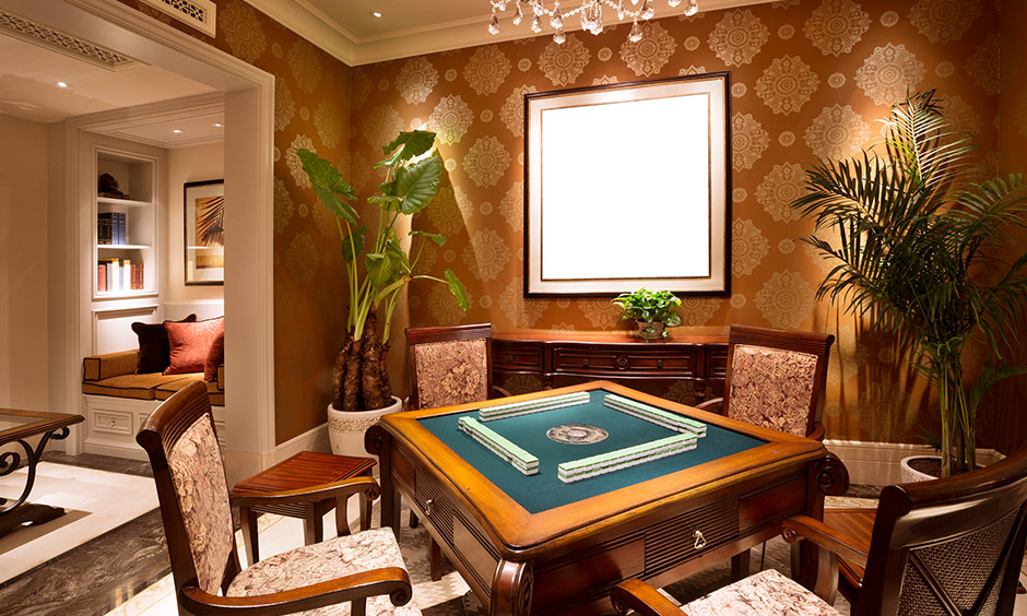 An indoor game room designed with a card table and chairs in a wooden finish create a beautiful ambience.