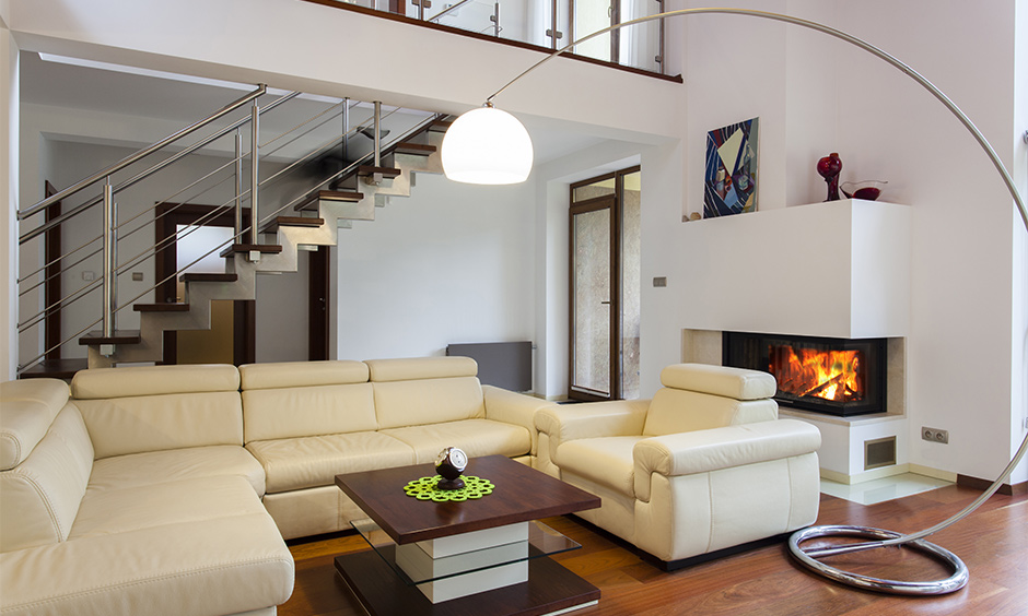 The modern living room with stairs with wooden steps and metal railing beautifully incorporates a mix of textural elements.