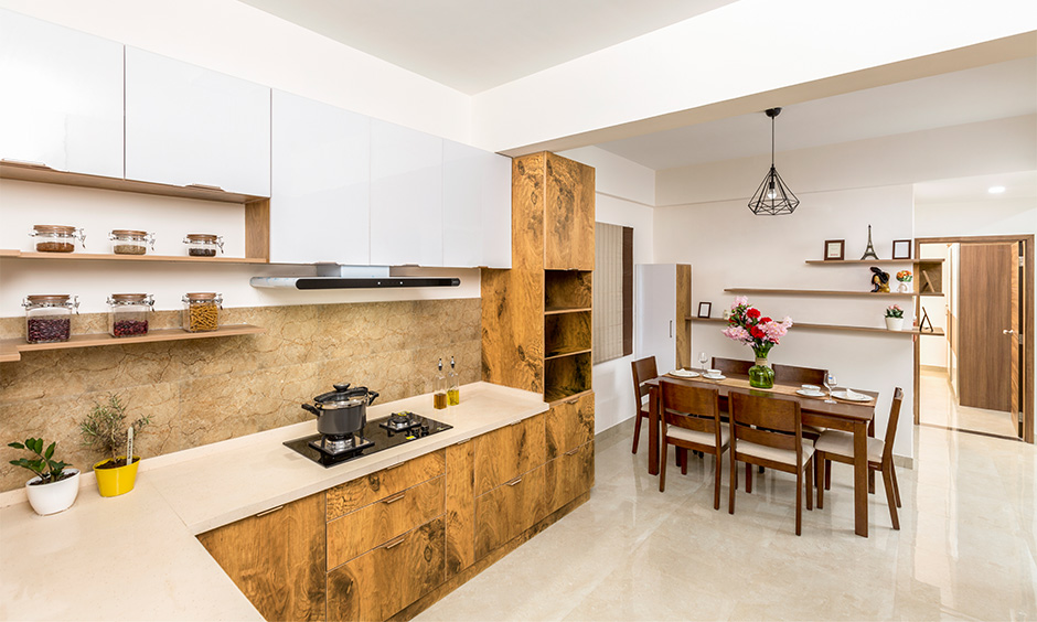 Mid-century modern interior design idea for kitchen cum dining area with wooden cabinets brings warm earthy feel.