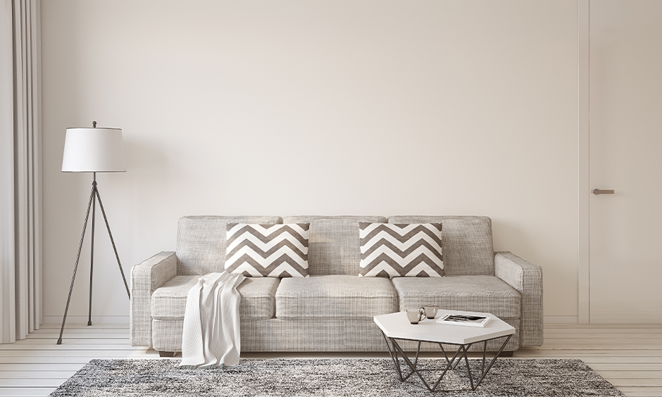 White living room in minimalist home design with a light grey sofa and rug creates airy, bright and elegant spaces.