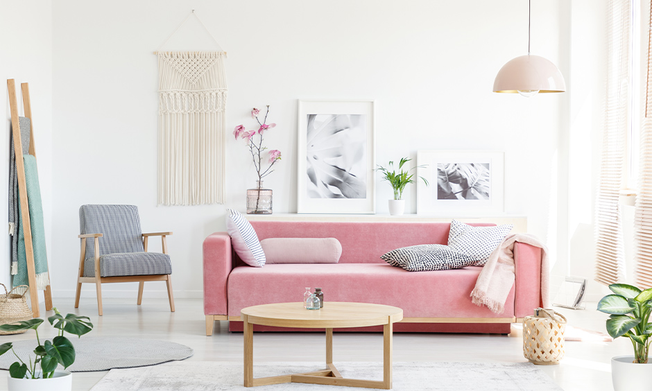 Minimalist Scandinavian living room in white colour with classic furniture and plants adds freshness.