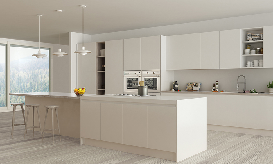 Off-white island kitchen in minimalist home design with a breakfast countertop and pendant lights look sleek.