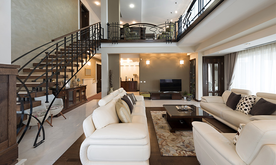 Open plan living room with stairs made from wood with metal brings a traditional vibe to the area.