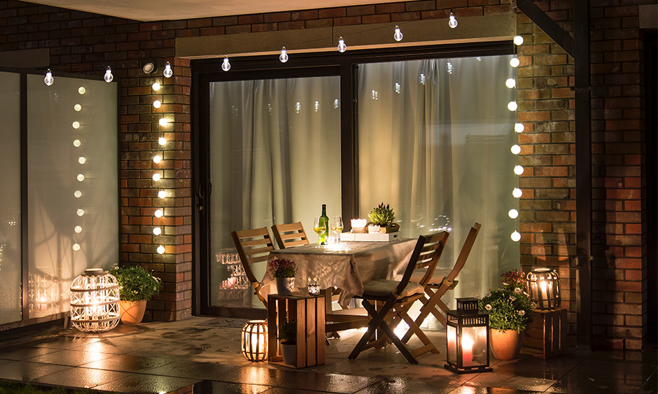 Spring decor for outdoor seating area with potted plants and comfy lights creates spring-inspired magic on the terrace