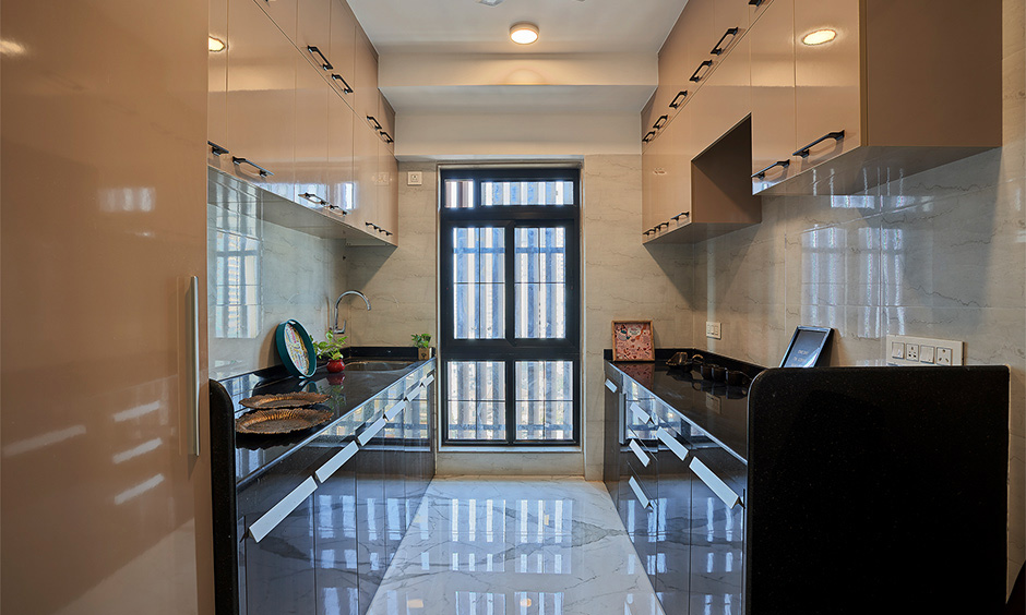 Parallel Indian kitchen interior idea for an apartment with loft cabinets look sleek and glossy.